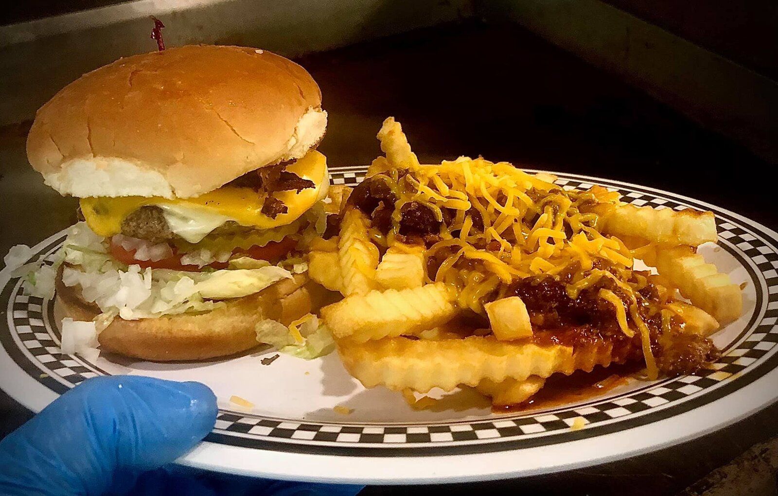 A burger with chili cheese fries