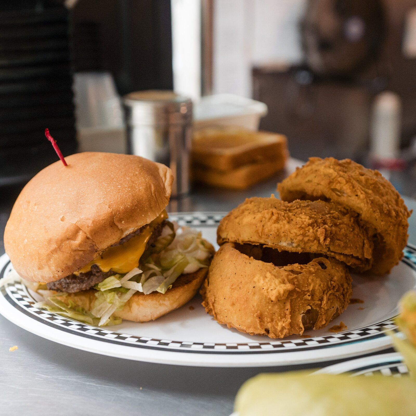 Burgers lined up on the counter, ready to serve