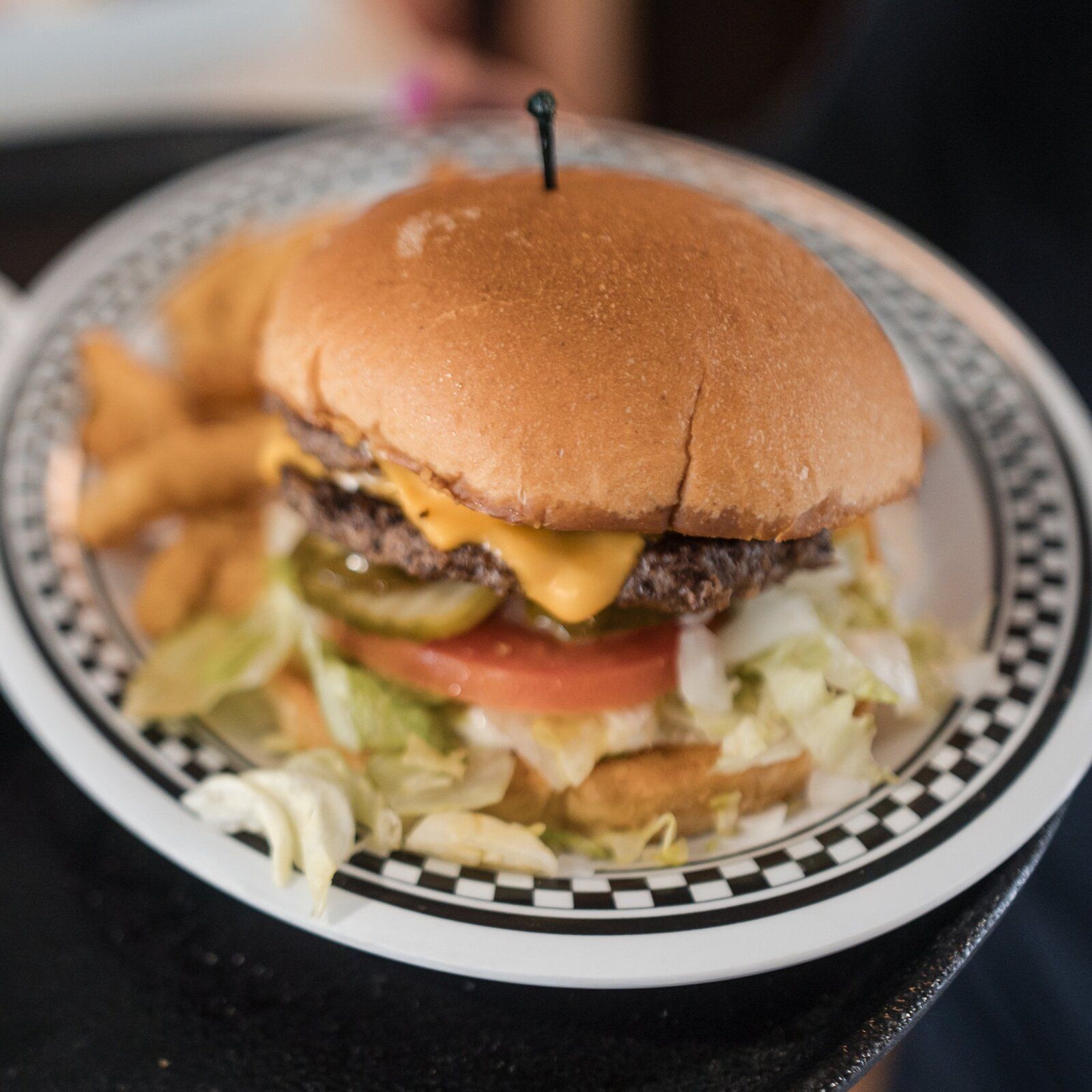 A cheeseburger with chicken strips and Texas toast